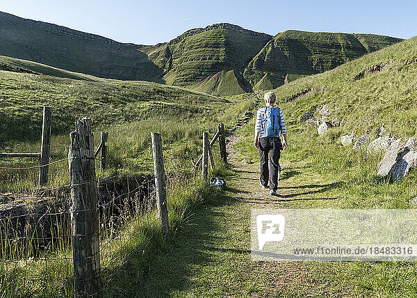 Woman hiking on mountain at sunny day  Brecon Beacons  Wales