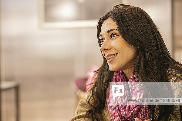 Happy beautiful woman sitting in cafe