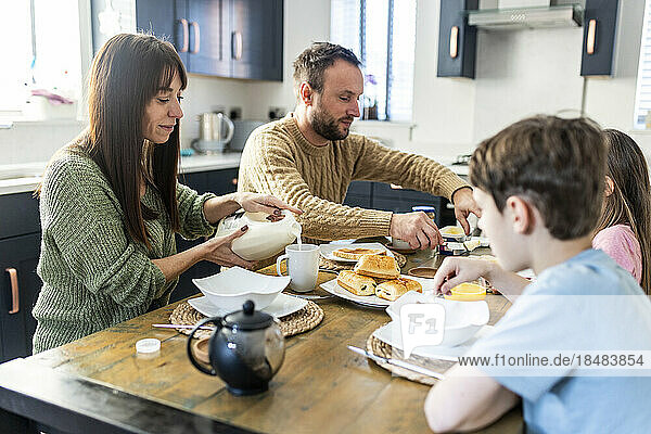 Family having breakfast together in kitchen