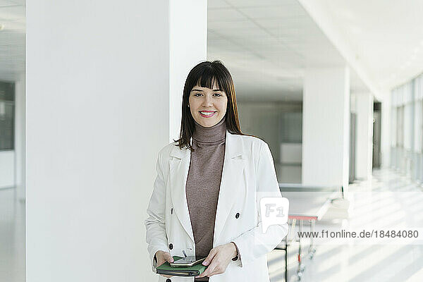 Portrait of smiling brunette businesswoman in office