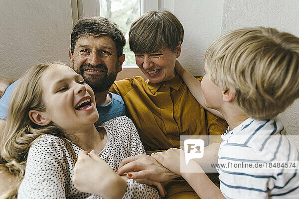 Cheerful woman having fun with family at home