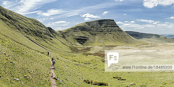Hikers walking on mountain at sunny day  Brecon Beacons  Wales