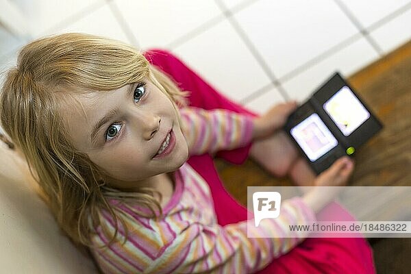 Girl (6) playing with Nintendo  Kiel  Germany  Europe