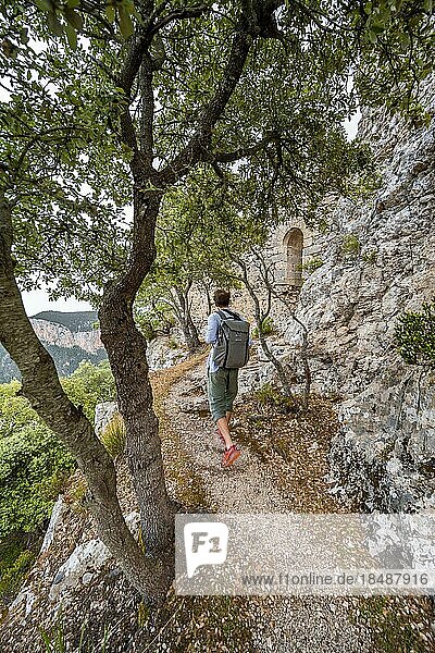 Hikers on the trail to the ruins of Castell Alaró  Serra de Tramuntana  Puig dAlaró  Majorca  Spain  Europe