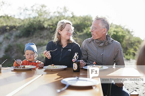 Summer party. Three generations eat together at one table.  Borkum  Germany  Europe