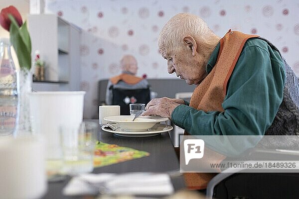 Old man in a nursing home spooning soup  Heidelberg  Germany  Europe