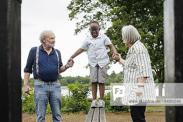 Grandparents on time. Grandparents with a boy on a playground.  Bonn  Germany  Europe