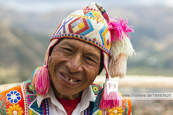 Smiling Peruvian man in colorful clothes  Sacred Valley  Cusco  Peru  South America