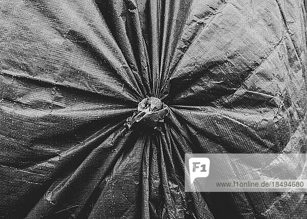 Close up of a tarpaulin cover  knotted with pleated pattern.