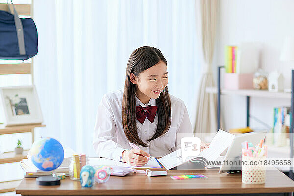 Japanese high school student in uniform studying