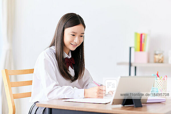 Japanese high school student in uniform studying