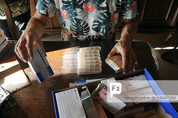 Liberal country nurse ensures the supply of drugs and distribution in the pillbox for the patients.