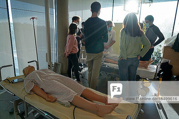 5th year medical students during a SimMan dummy cardiac massage workshop.