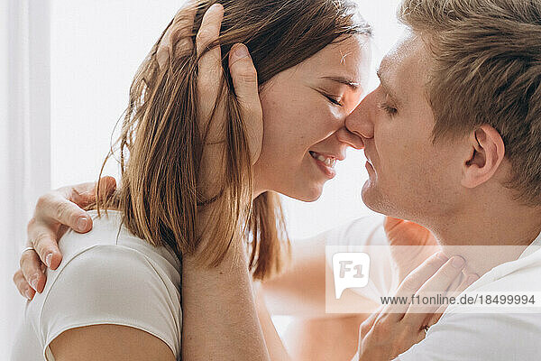 Close-up of a couple of lovers kissing on a white background