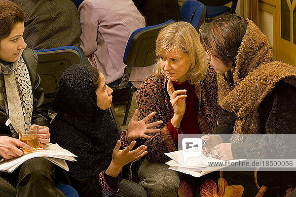 Women work together at a business training seminar in Kabul.