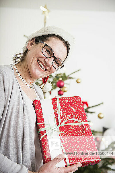 Portrait of mature woman with Christmas present