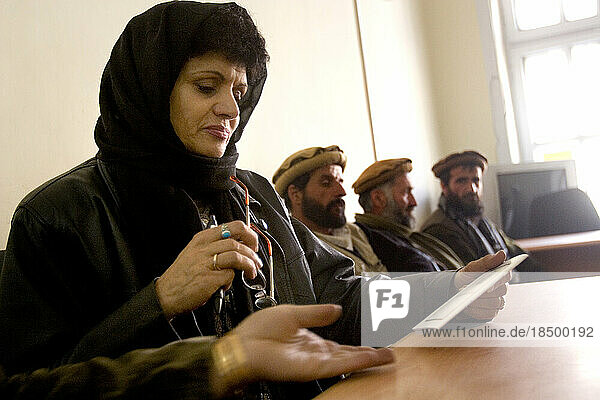 Woman attends a Kabul Provincial Council meeting where she is an elected official.