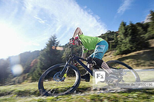 Mountain biker riding on track  Tirol  Austria