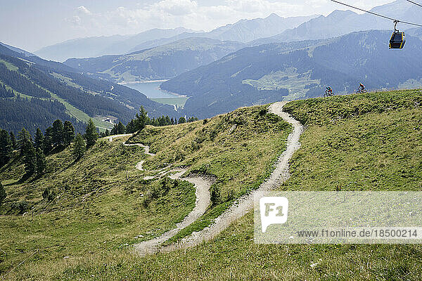 Two mountain bikers riding on uphill  Zillertal  Tyrol  Austria