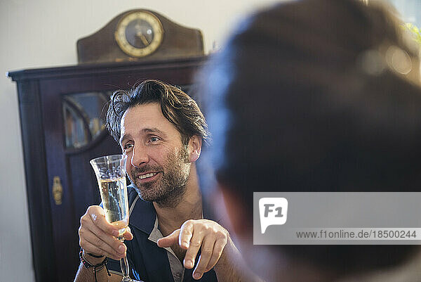 Man holding a glass of sparkling wine