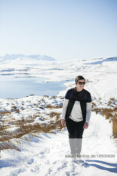 Millenial Woman hiking through snow on Isle of Skye Scottish highlands