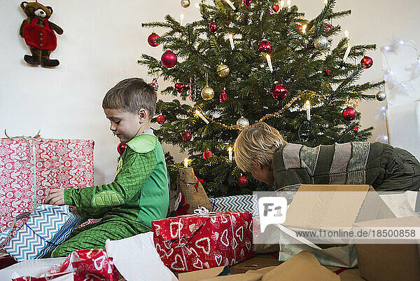Children opening Christmas gift at home