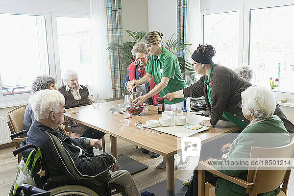 Nurses preparing food for senior residents in rest home