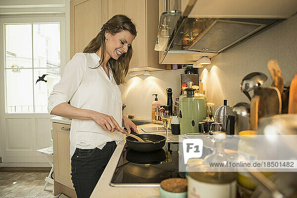 Young woman preparing food in kitchen  Munich  Bavaria  Germany