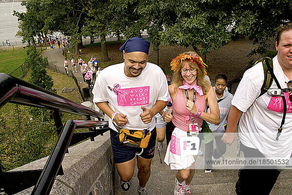 Walkers go up steps during the Avon Walk for Breast Cancer in New York City.