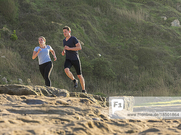 Man and woman jogging on single trail
