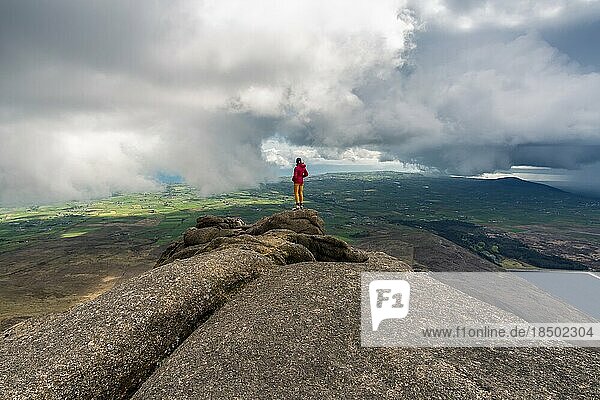Woman standing on top of the Slieve Binnian Mountains