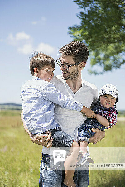 Happy man with his son enjoying picnic in the countryside  Bavaria  Germany