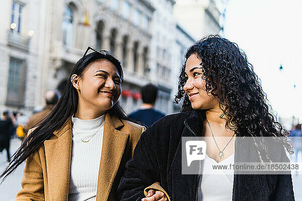 stock photo of two happy friends visiting the city