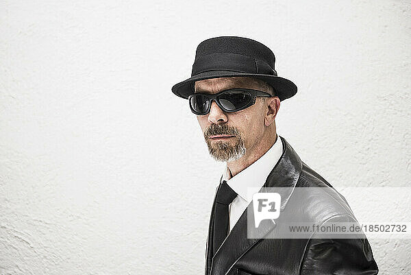 Portrait of a mature man wearing sunglasses and hat  Munich  Bavaria  Germany