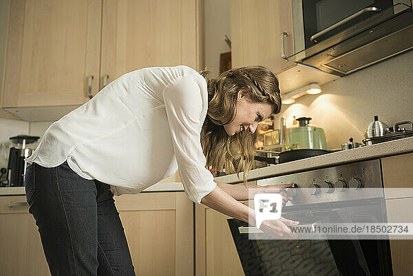 Young woman working in kitchen  Munich  Bavaria  Germany
