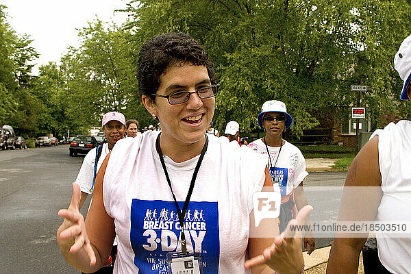Breast cancer walker stretches her hands at a Washington DC event.