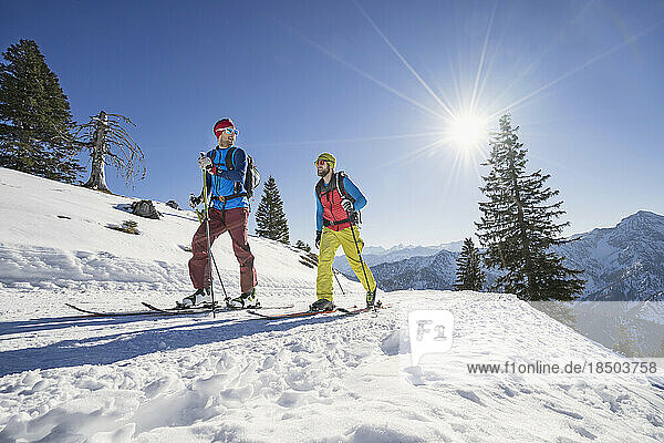 Skiers walking on snow mountain