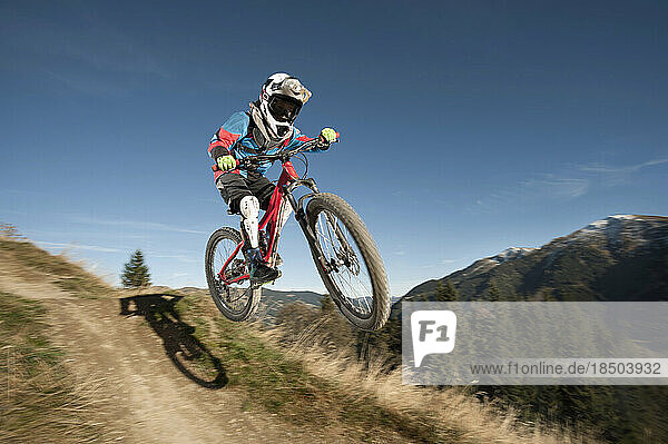 Mountain biker jumps over a bump  Saalbach-Hinterglemm  Zell am See  Salzburg  Austria