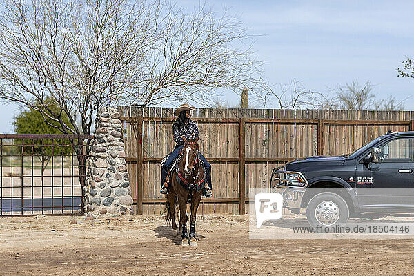 A cowgirl on horseback at the Arizona Black Rodeo