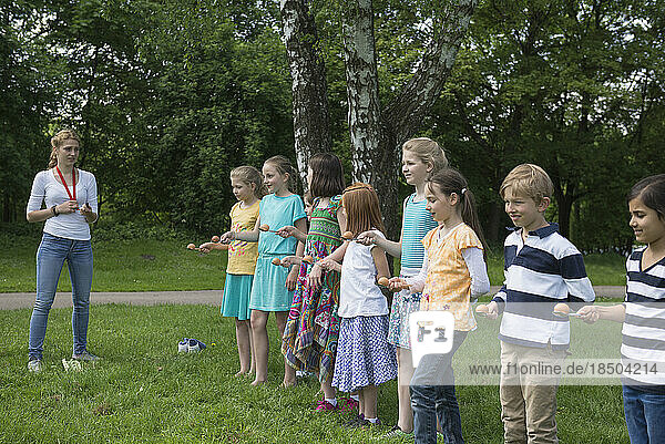 Group of children wait in a row to start the egg race  Munich  Bavaria  Germany