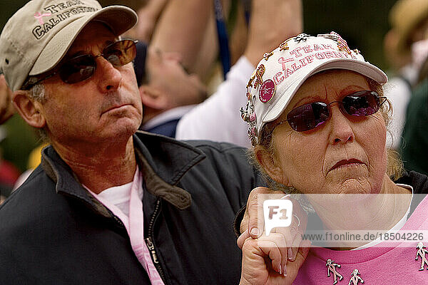 Couple hold hands during an emotional moment at a breast cancer walk in San Francisco.