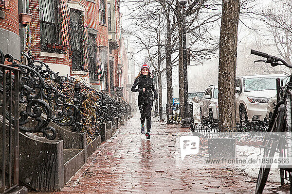 Girl Running on the Sidewalk in a Snowstorm