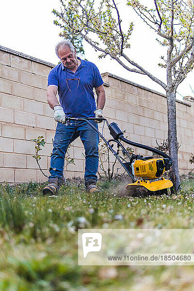 stock photo of man working in the garden