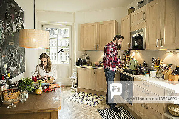 Couple in kitchen and preparing food  Munich  Bavaria  Germany