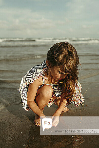 Little Girl Searching for Shells on the Beach in Corpus Christi Texas