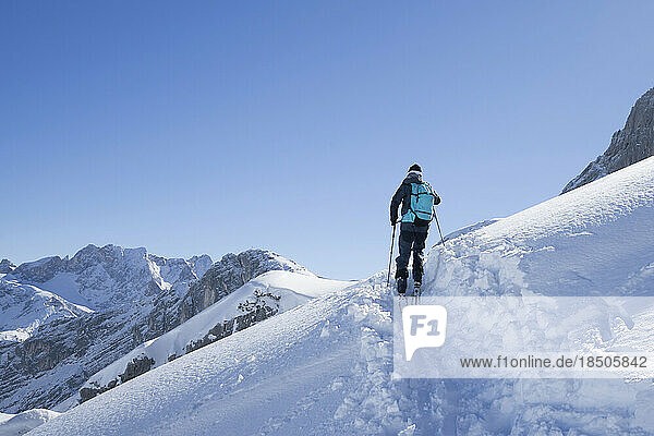 Low angle view of skier climbing the ski slope  Bavaria  Germany  Europe