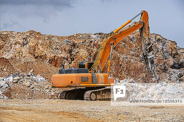 excavator working at gravel mine in Thailand