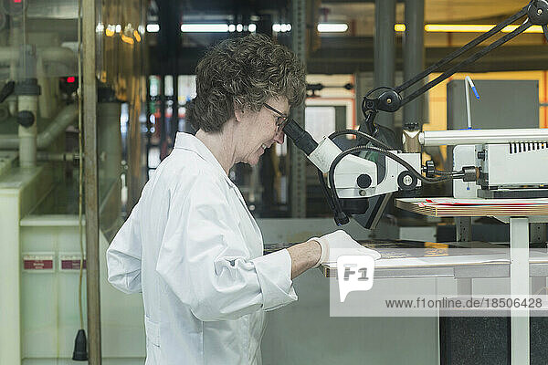 Female engineer examining circuit board in industry  Hanover  Lower Saxony  Germany
