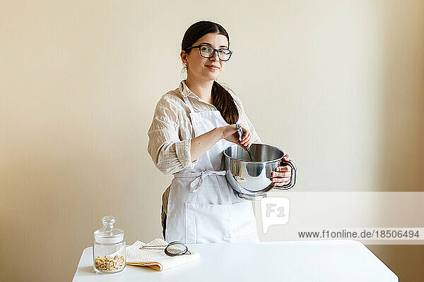 girl confectioner entrepreneur in her kitchen while cooking