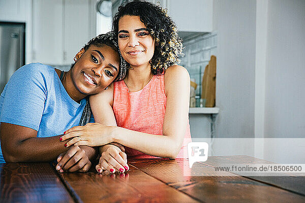 Portrait of smiling homosexual couple sitting at table
